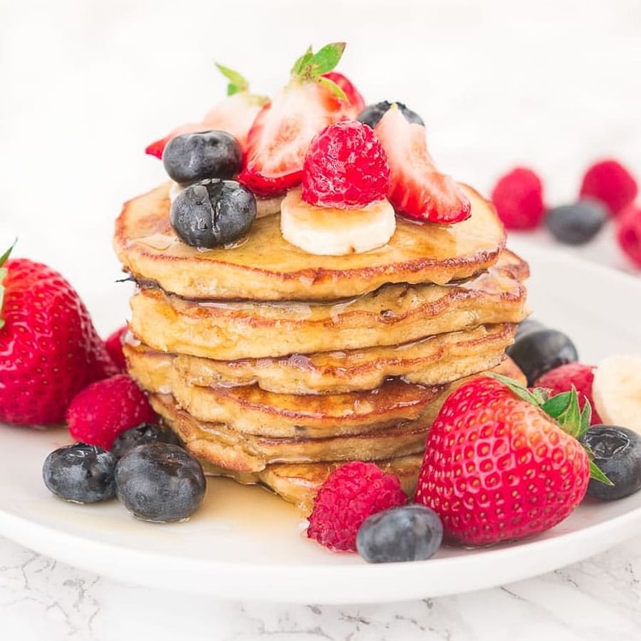 Delicious Paleo Pancakes topped with fresh berries and nuts